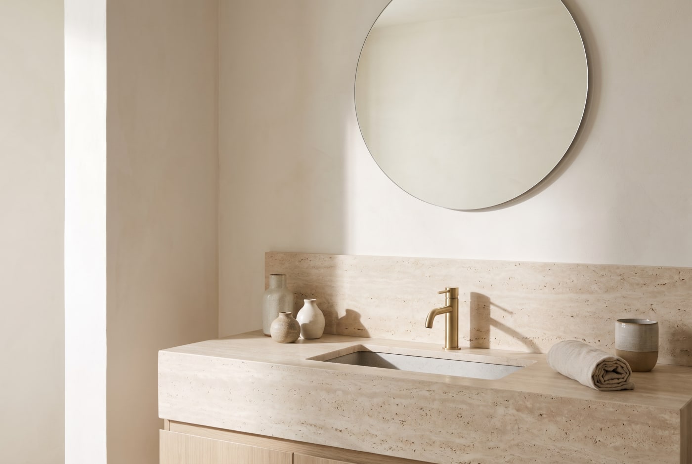 LUMEN — a travertine bath in soft daylight.